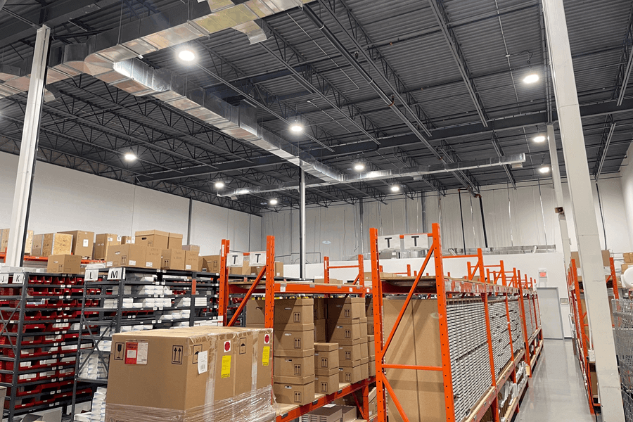 UFO High Bay LED Lights in Warehouse. Networked Lighting Controls Installed On The LED UFO High Bay Fixtures