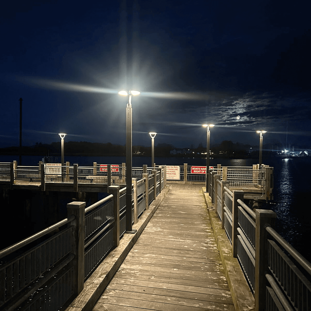 The Light Efficient Design SL-CPT-25L-40K-BK-G1 Post Top 2500 Lumen 4000K Solar Walkway Light Installed On A Pier. Commercial Solar Lighting from LED Network